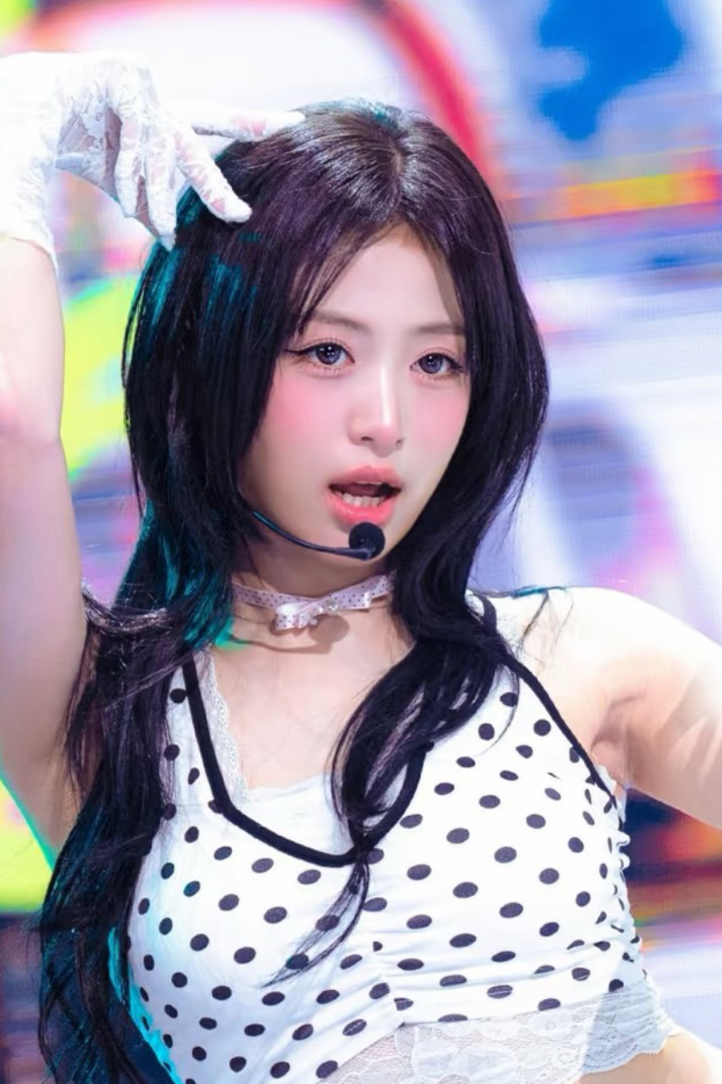 K-pop singer Ahyeon performing on stage wearing a lace choker